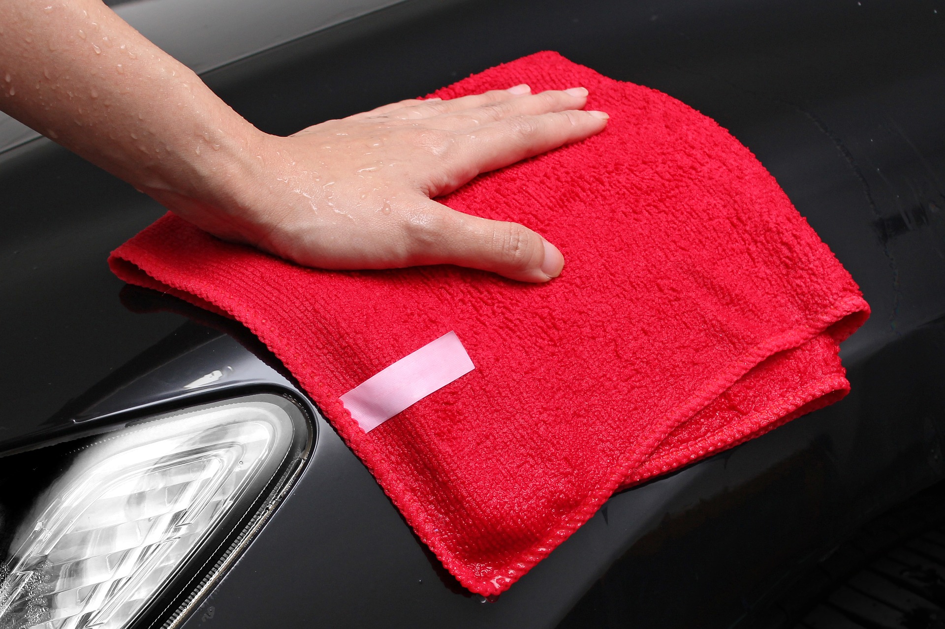 Red microfiber cloth drying Deluxe Wash car wash package from Fast Auto Wash of Sioux Falls, SD.